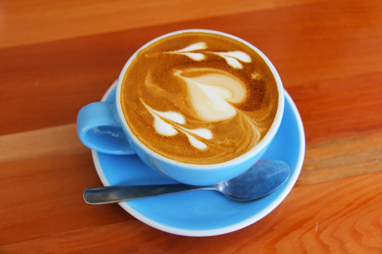 Latte art in a blue cup